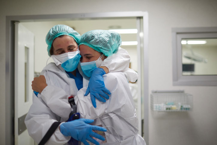 nurses comforting one another