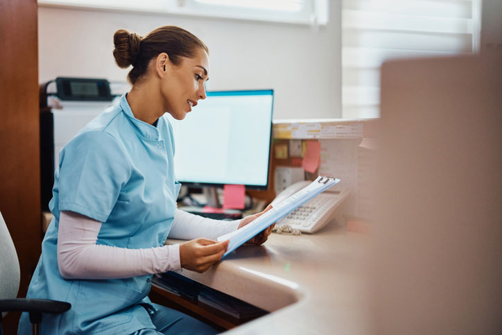 dnp looking over orders at nurse's station