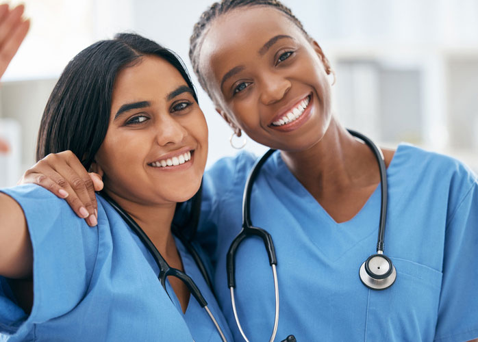 two dnp students in scrubs