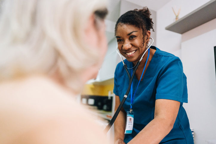 female dnp taking care of elderly woman