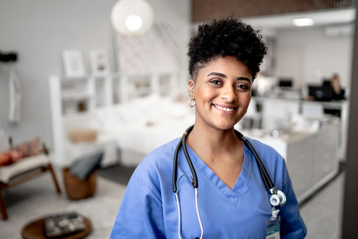 nurse smiling in hospital room