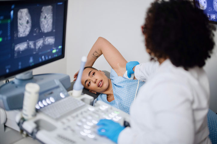 woman on bed getting ultrasound