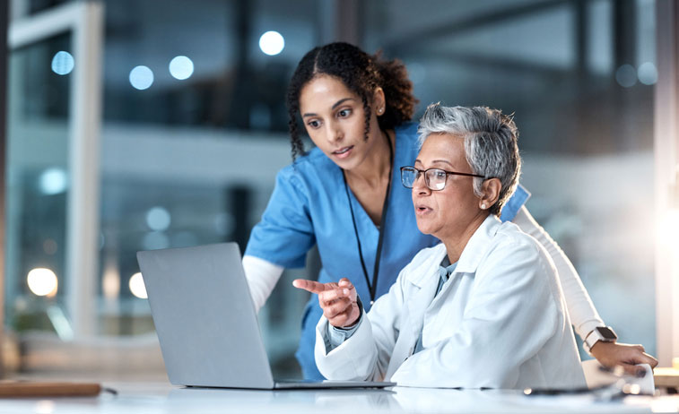 dnp and other nurse looking at charts on computer