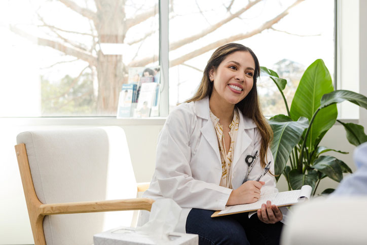 dnp taking notes while talking with patient