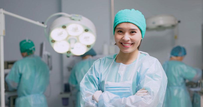 crna in the operating room, smiling